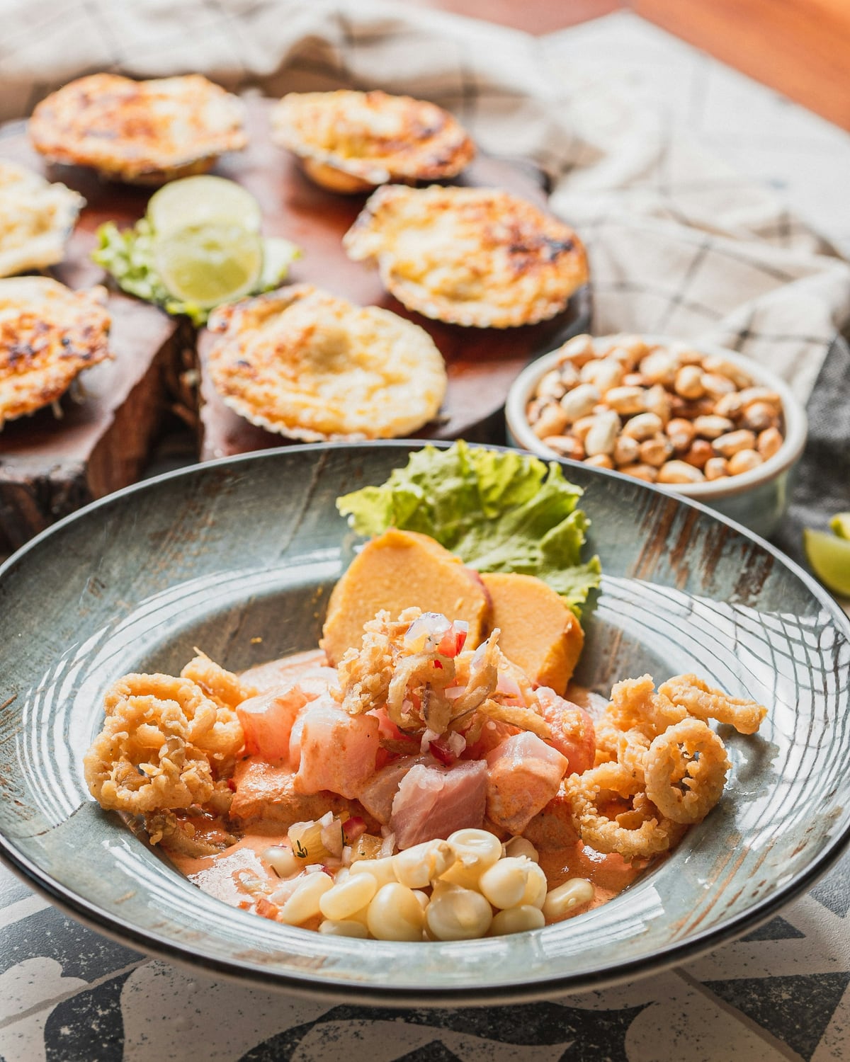 Ceviche peruano con calamares fritos y maíz en un plato hondo